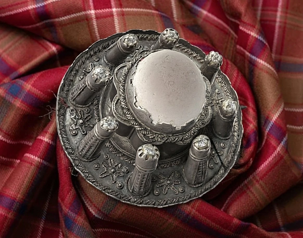 The Brooch of Lorne — replica displayed at Dunollie House, Oban, on the Dalriada tartan. The original is on loan to National Museums Scotland, Edinburgh.